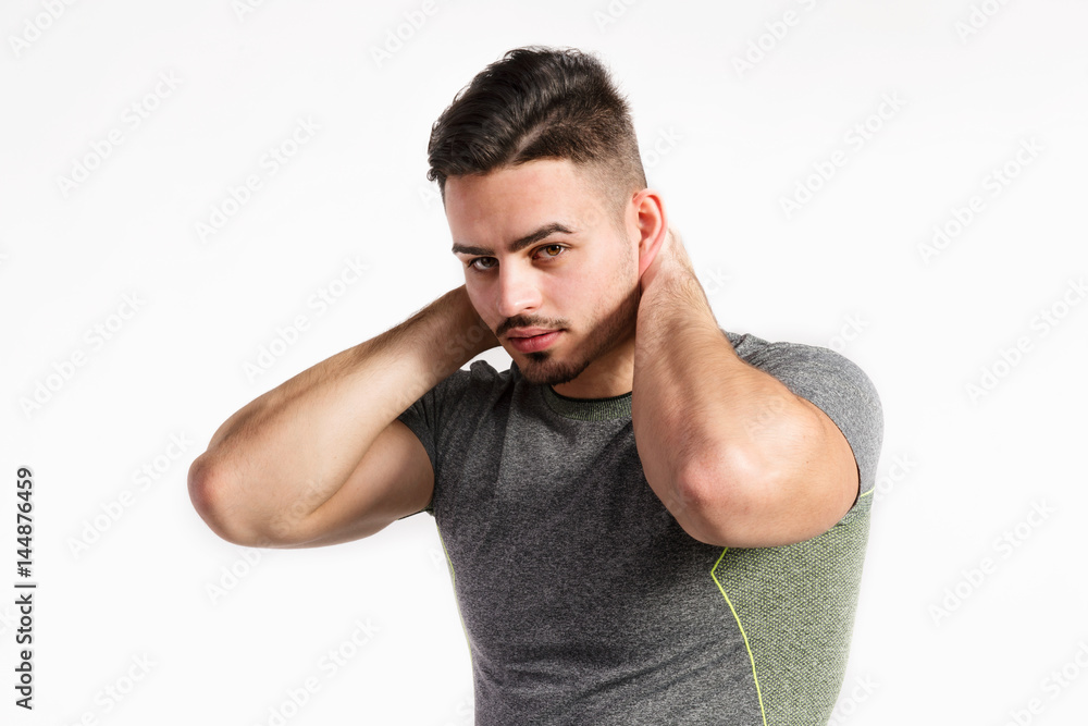 Young handsome fitness man in gray t-shirt, studio shot. Young handsome fitness man in gray t-shirt, studio shot.