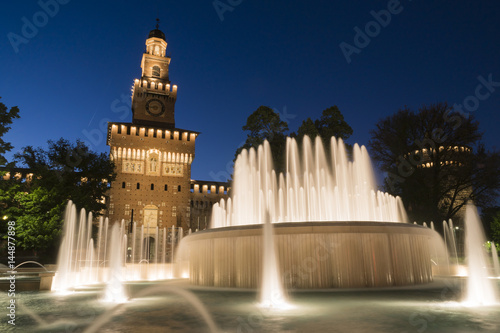Milan, Italy. Sforzesco castle and Piazza Castello fountain. Night view