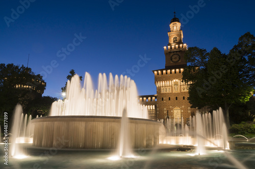 Milan, Italy. Sforzesco castle and Piazza Castello fountain. Night view