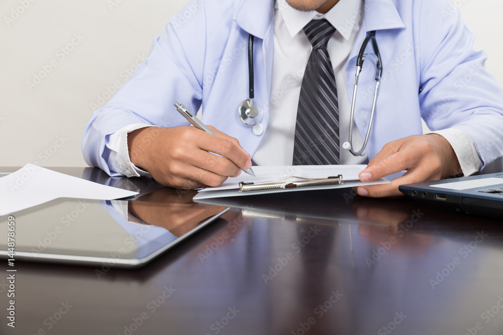 doctor writing RX prescription in medical office clinic on desk, stethoscope with clipboard doctor writing RX prescription in medical office clinic on desk, stethoscope with clipboard
