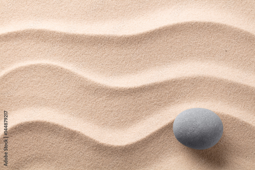 round stone on beach sand. Zen meditation rock.