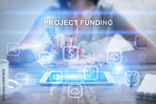 Woman using tablet pc, pressing on virtual screen and selecting project funding
