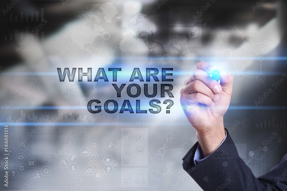Businessman is drawing on virtual screen. what are your goals concept. Businessman is drawing on virtual screen. what are your goals concept.