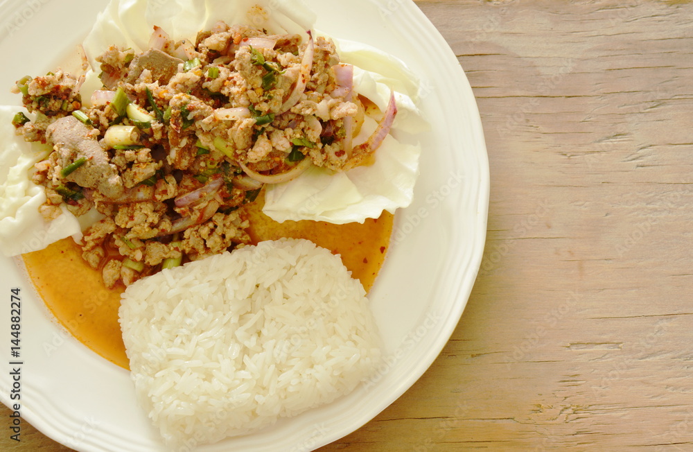 Thai spicy chop pork salad eat couple with sticky rice and fresh vegetable Thai spicy chop pork salad eat couple with sticky rice and fresh vegetable