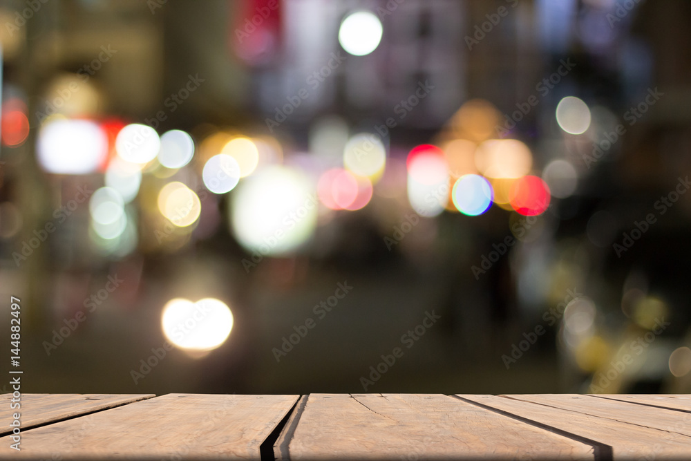 light on city blurred background on wooden table light on city blurred background on wooden table
