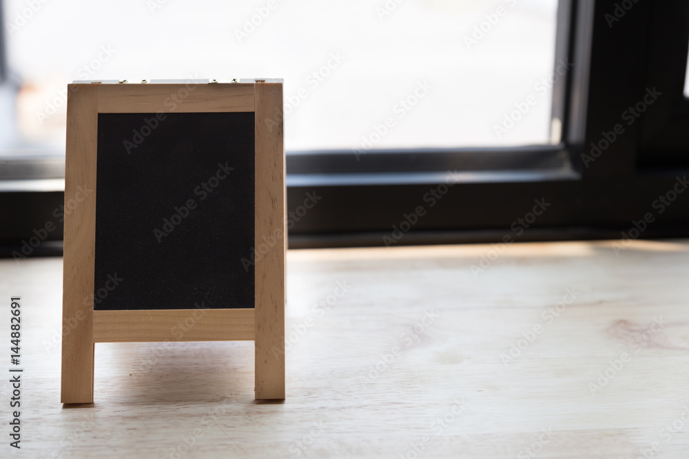 black board with blank space for text on wood table