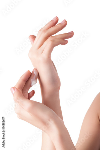 Perfect soft hands on isolated background with the drop of moisturizing cream on. young girl wearing hand cream