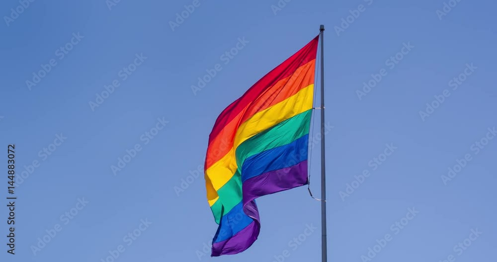 Slow motion gay pride flag blowing in the wind. Slow motion gay pride flag blowing in the wind.