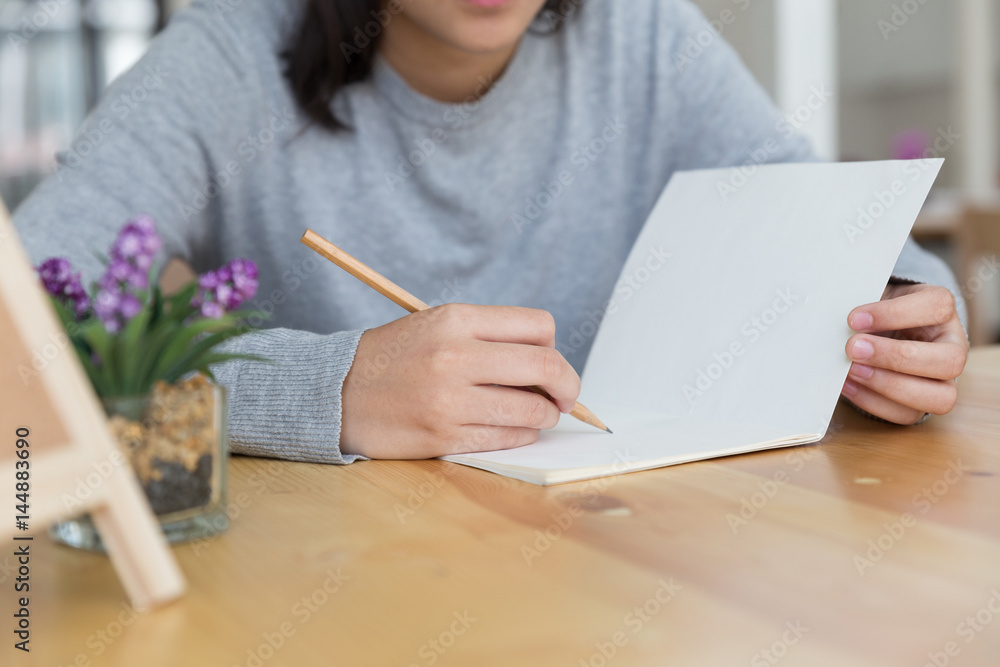 asian girl female teenager studying at school. Student writing note on wood desk - education and learning concept asian girl female teenager studying at school. Student writing note on wood desk - education and learning concept
