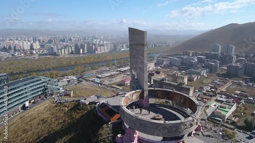 Zaisan Memorial monument USSR soldier with flag. Capital of Mongolia Ulaanbaatar observation deck. Tourist walk uphill mountains. Aerial Drone flight around 4k footage. photo