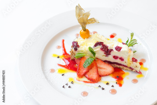 Cheesecake with berries on white plate