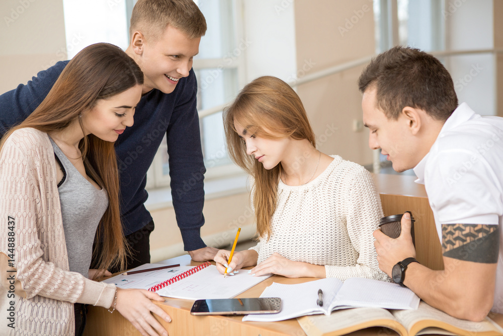 Fototapeta premium Group of university or college students studying together in an auditorium