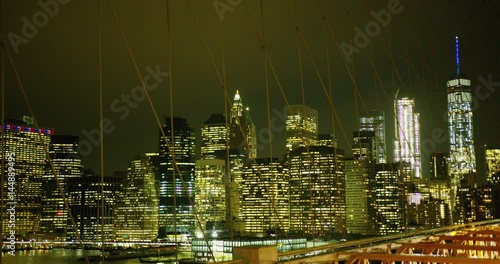 Manhattan skyline as seen on the Brooklyn Bridge at night.