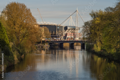 Millennium Stadium and River Taff from Bute Park. National stadium of Wales in evening light in Cardiff, UK
