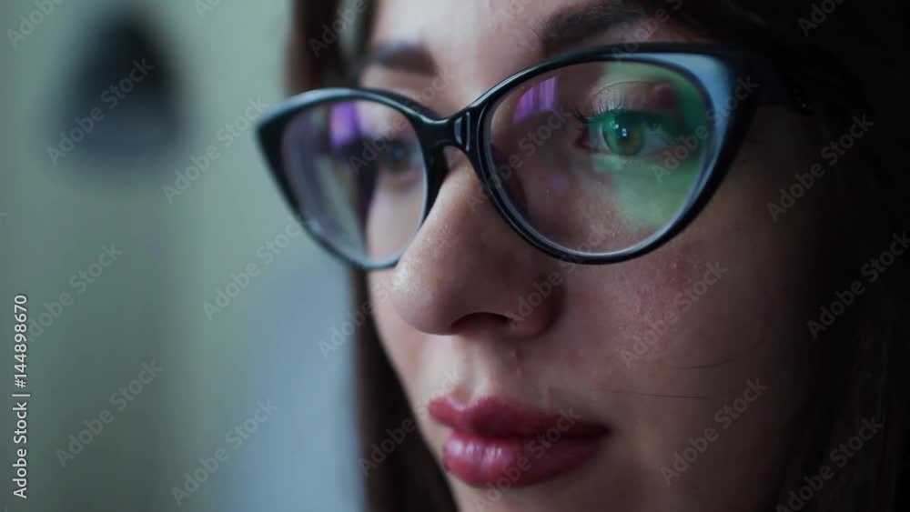 Woman with glasses eyes looking at the tablet computer, surfing the Internet, close-up Woman with glasses eyes looking at the tablet computer, surfing the Internet, close-up