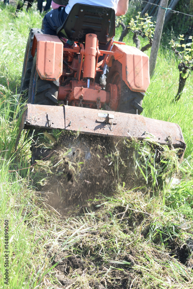 plowing of the soil with old rotary hoe plowing of the soil with old rotary hoe