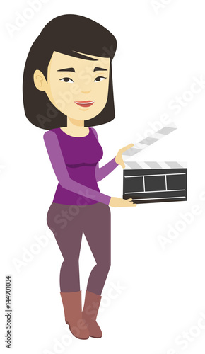 Smiling woman holding an open clapperboard.