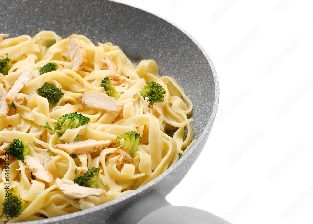 Frying pan with delicious chicken Alfredo on white background