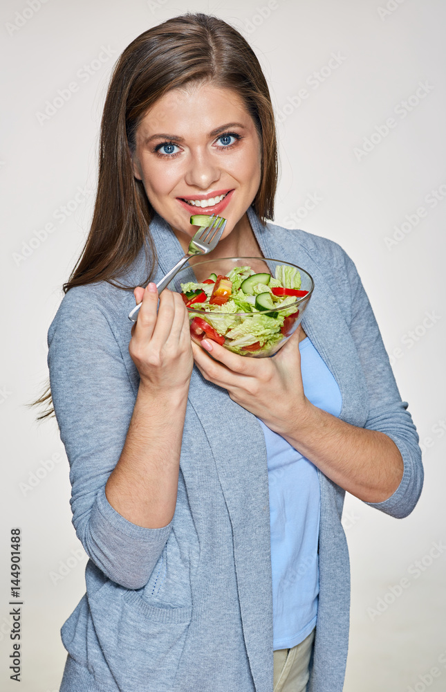 Young woman eating healthy food with lettuce, tomato Young woman eating healthy food with lettuce, tomato