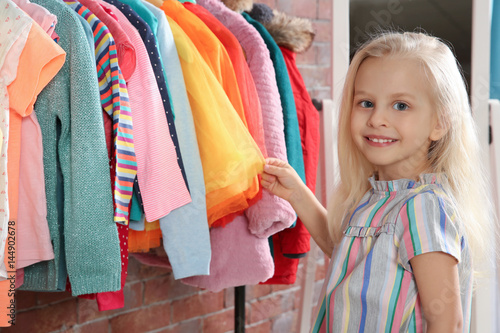 Cute little girl choosing c...
