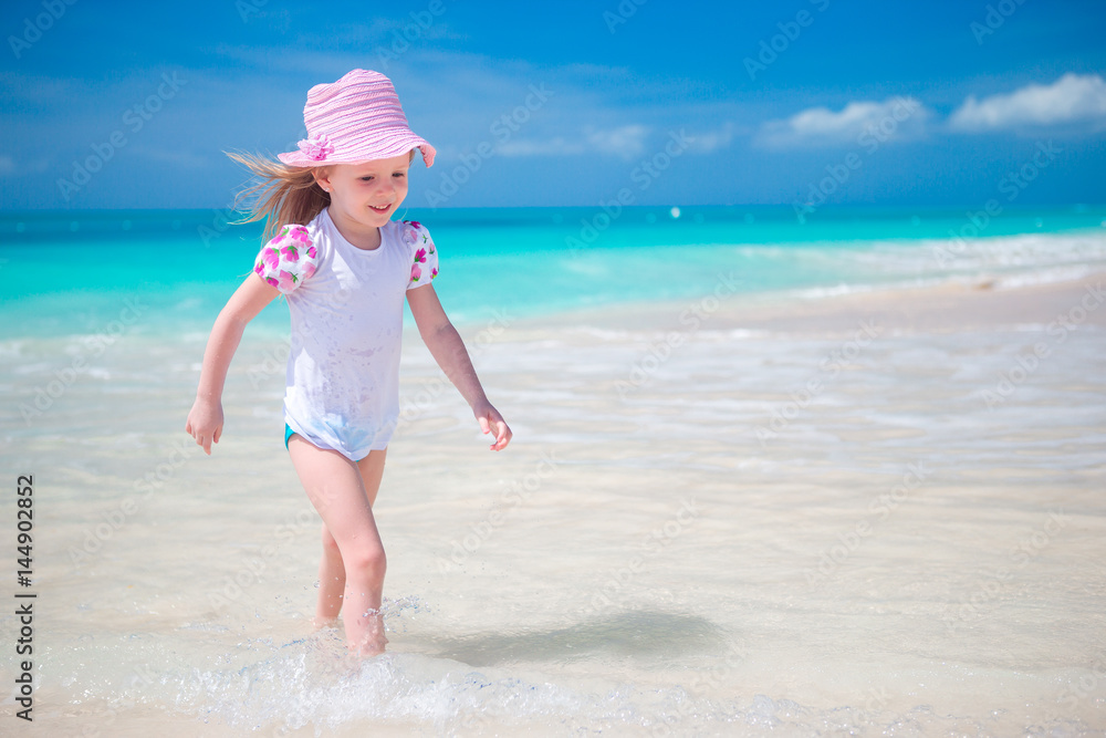Adorable little girl at beach during summer vacation. Adorable little girl at beach during summer vacation.