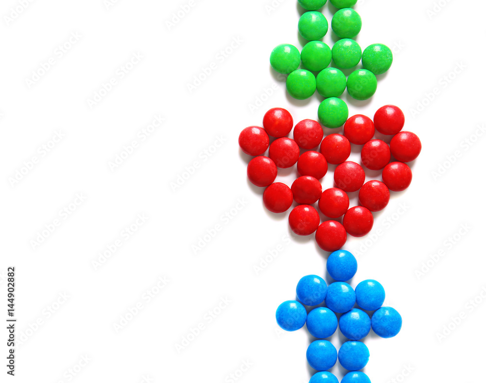 Heart and arrows made of delicious candies on white background Heart and arrows made of delicious candies on white background