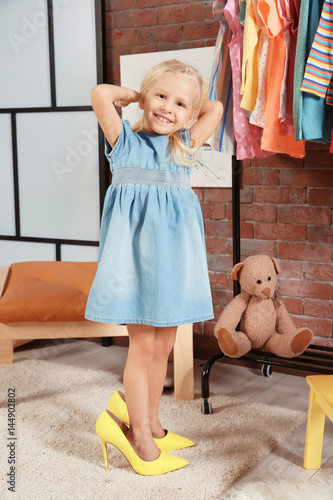 Cute little girl in dressin...