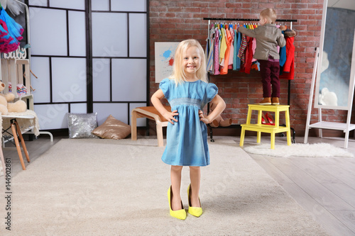 Cute little girl in dressin...