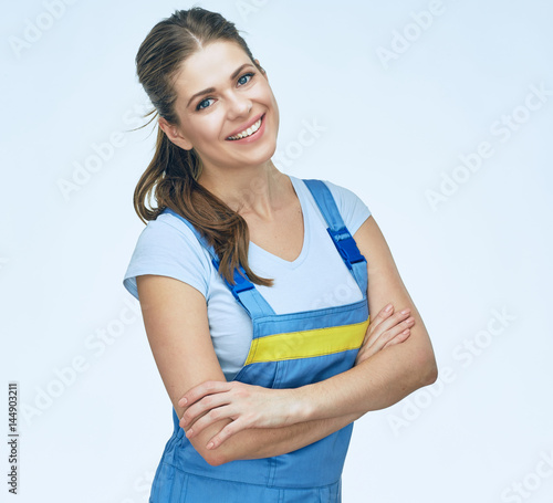 Smiling woman repairer wearing coverall.