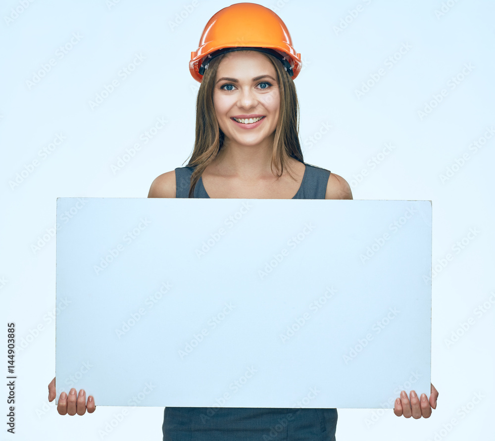 Smiling Business woman builder presenting white adertising banner. Smiling Business woman builder presenting white adertising banner.