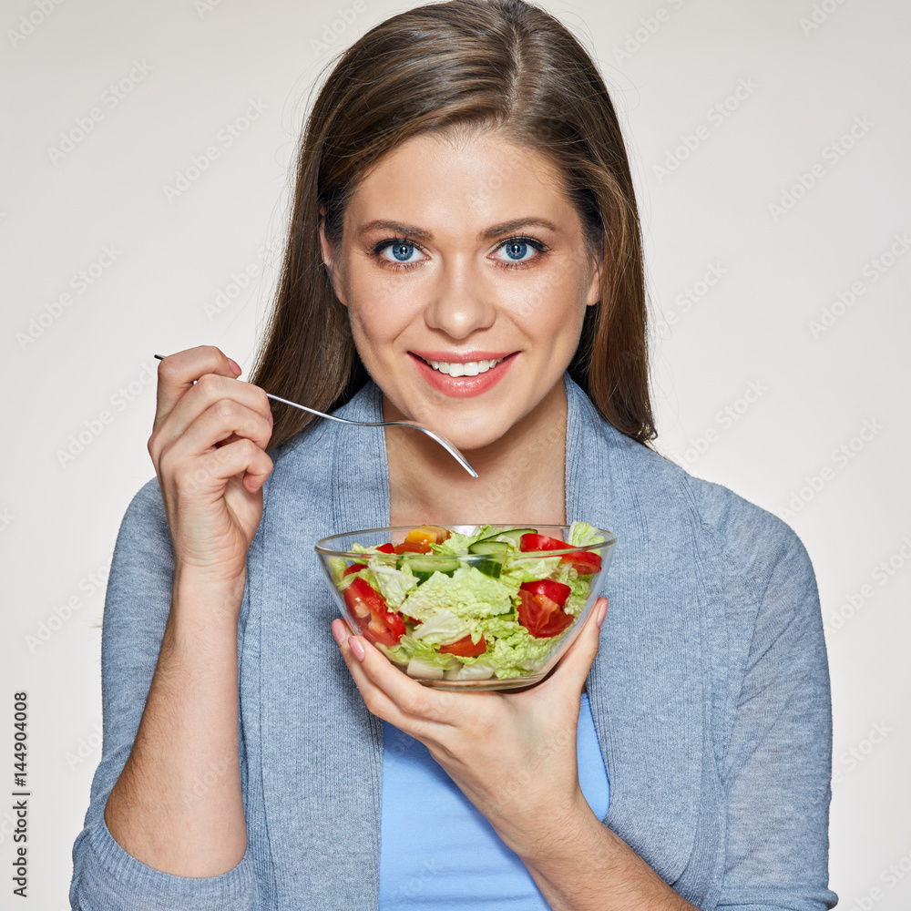 Smiling woman holding glass dish with salad. Smiling woman holding glass dish with salad.