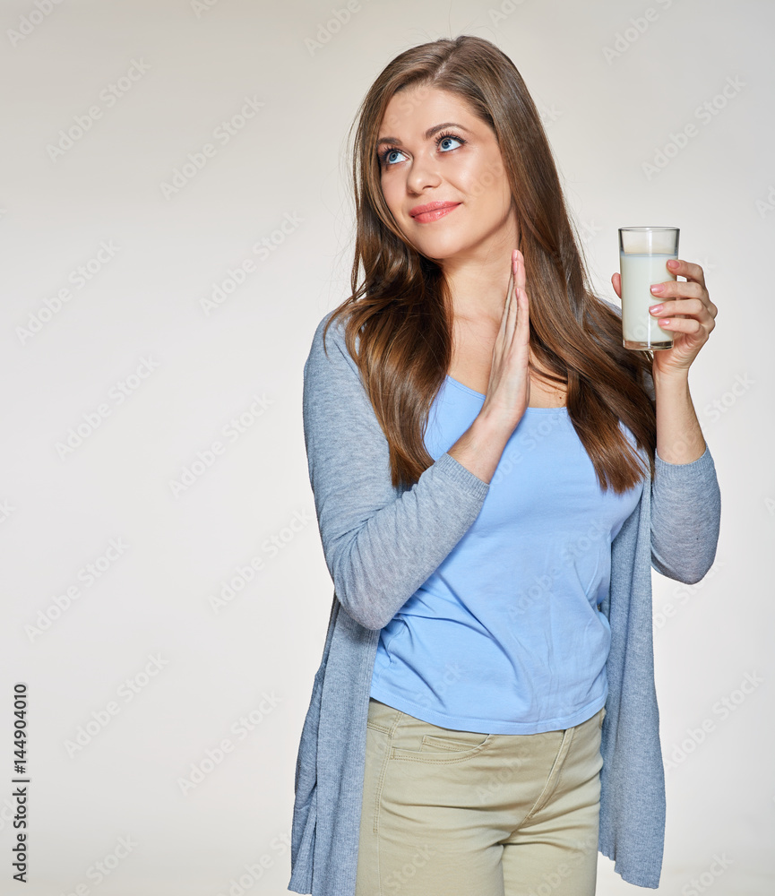 Young woman holding milk glass with disgust emotion. Young woman holding milk glass with disgust emotion.