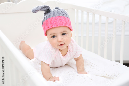 Cute little baby in cradle at home