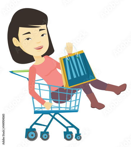 Happy woman riding by shopping trolley.