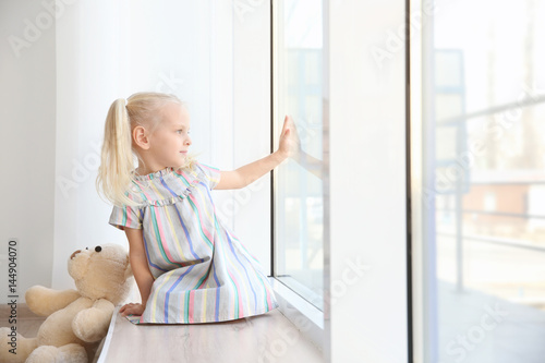 Cute little girl sitting on...