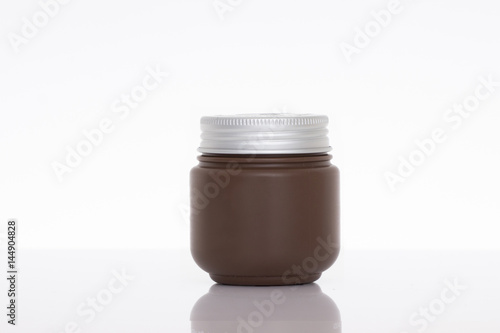 Jar of face cream isolated on white background with reflection