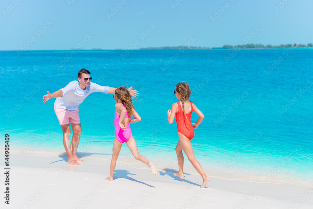 Happy family enjoying beach time and have a lot of fun