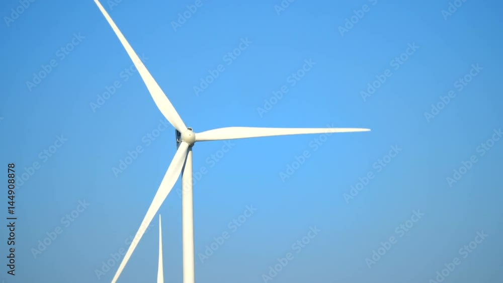Many wind generators are spinning against the blue sky, close-up photography Many wind generators are spinning against the blue sky, close-up photography