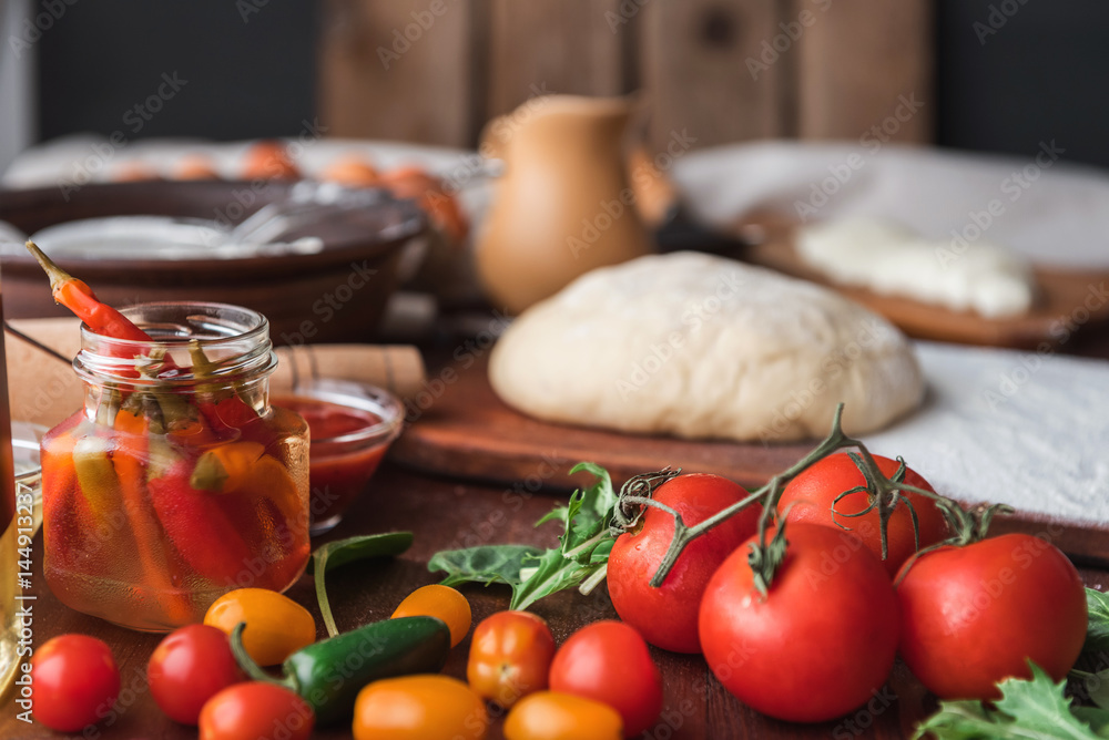 Step-by-step boss makes a pizza margarita. Dough and pizza ingredients