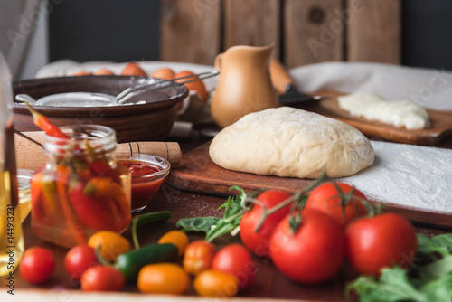 Step-by-step boss makes a pizza margarita. Dough and pizza ingredients