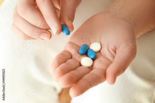 Hands of woman with pills, closeup