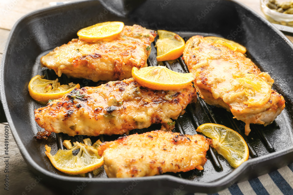 Frying pan with delicious chicken piccata, closeup Frying pan with delicious chicken piccata, closeup