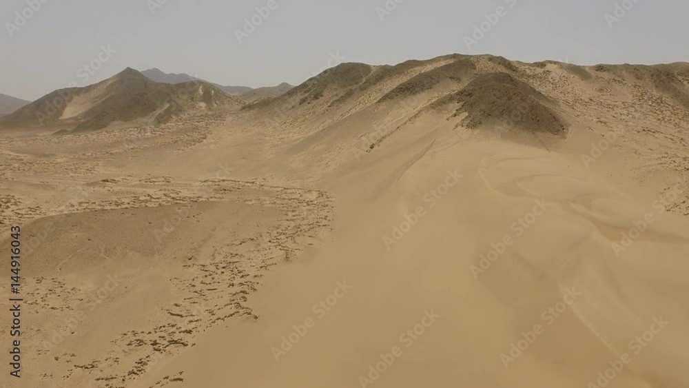 Aerial of sand dunes in a desert in Peru, South America. Aerial near the city of Caral Aerial of sand dunes in a desert in Peru, South America. Aerial near the city of Caral