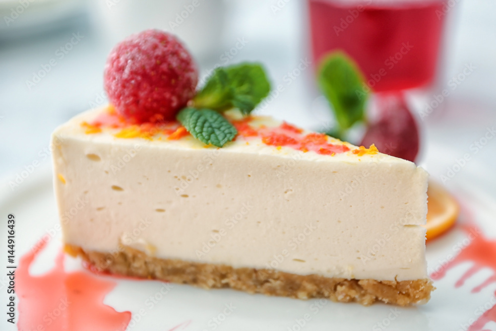 Tasty cheesecake slice with strawberry on plate Tasty cheesecake slice with strawberry on plate
