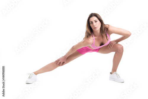 Healthy young fitness personal trainer woman warm up before sport training. Active lifestyle female isolated on white.