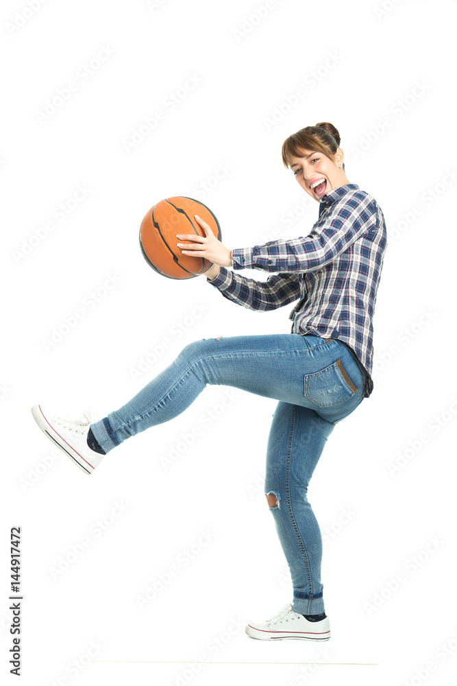 Happy attractive young woman holding a basketball isolated on white background. Happy attractive young woman holding a basketball isolated on white background.