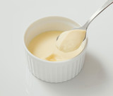 White creamy yohurts with spoon on white background