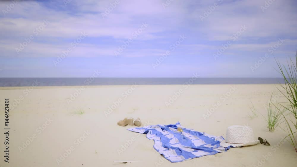 Girl spending free time on seashore, taking sunbath. Young long hair woman resting on sandy beach dunes in summer 4K ProRes HQ codec Girl spending free time on seashore, taking sunbath. Young long hair woman resting on sandy beach dunes in summer 4K ProRes HQ codec