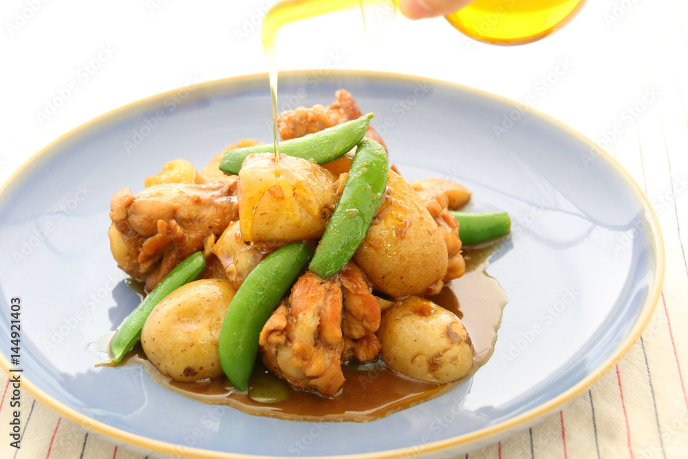Potatoes sauteed with chicken and green beans on platter Potatoes sauteed with chicken and green beans on platter