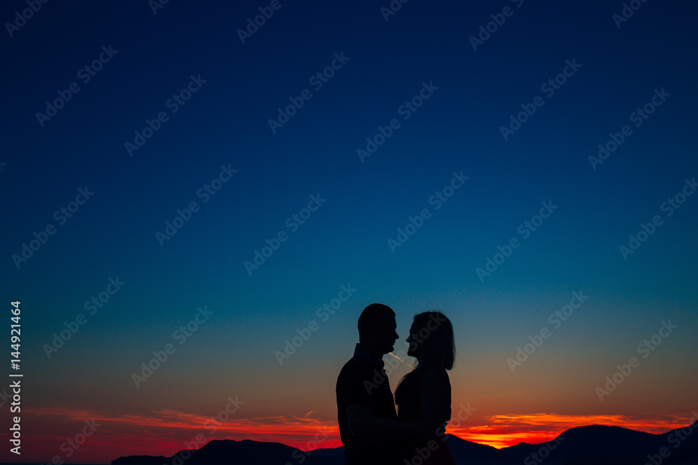 Silhouettes at sunset on the beach in Montenegro